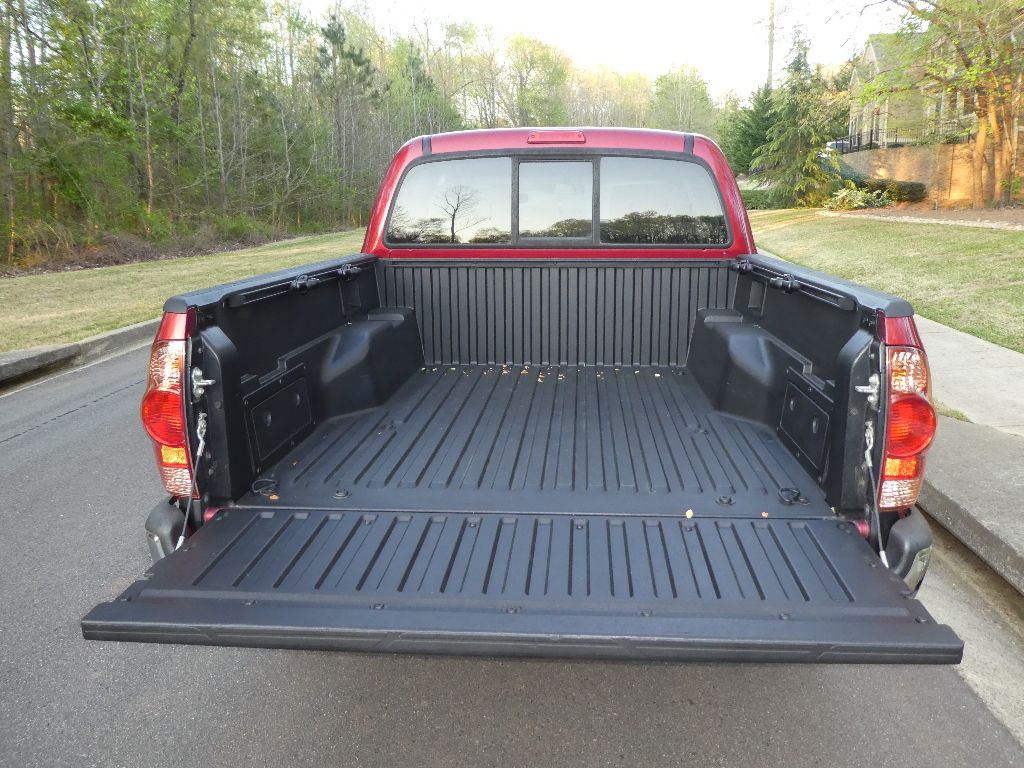FACTORY BED LINER WITH STORAGE BINS AND ADJUSTABLE TIE DOWNS